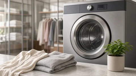 Front-loading garment cleaning machine beside folded fabrics